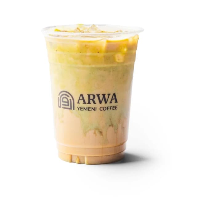 An Arwa pistachio latte in a branded cup